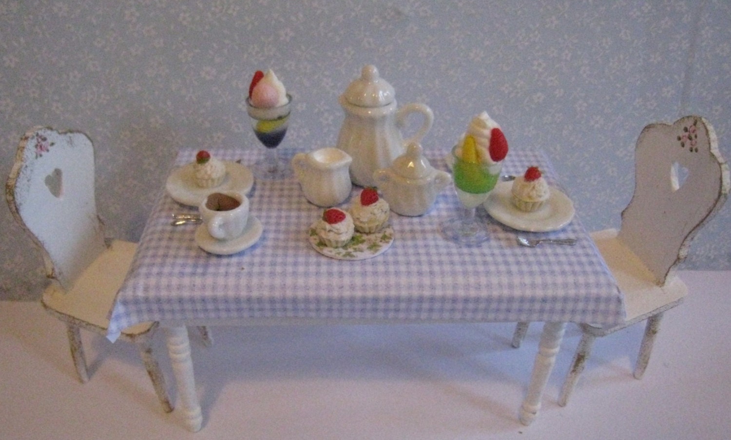 White table, ready for a party for two. .   Twelfh scale dollhouse miniature