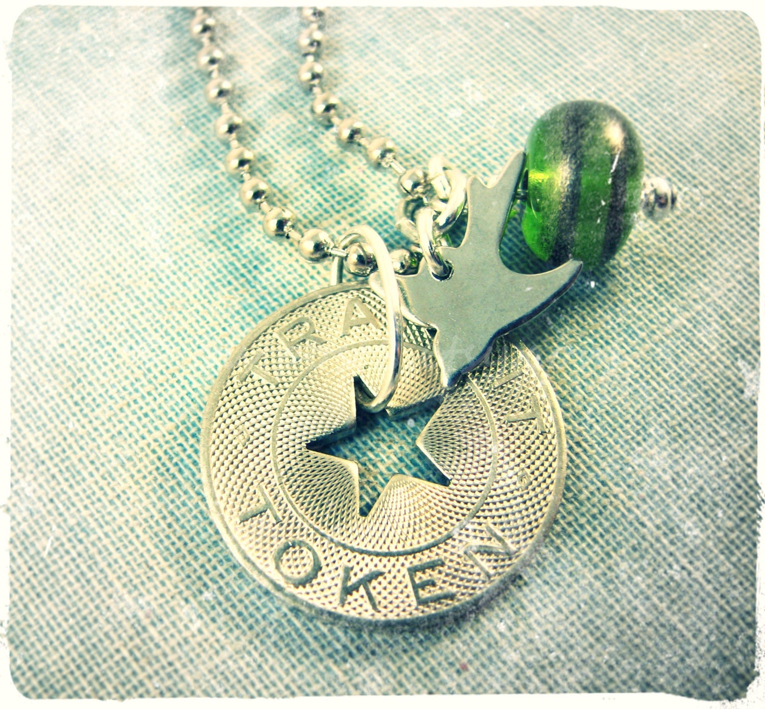 Traveler's charm necklace. Transit token, lampwork glass, bird charm. Rustic, boho, post-apocalyptic. Free US shipping.