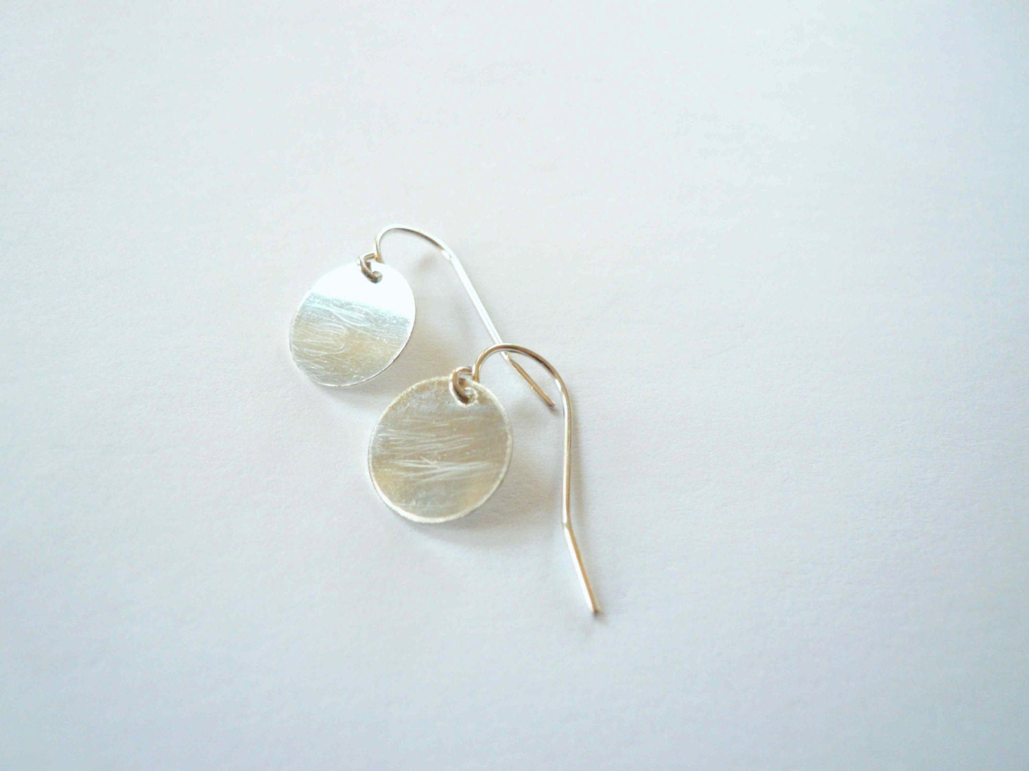 Silver circle earrings. Tiny sterling silver discs on .925 sterling silver ear wires. Dainty jewelry.