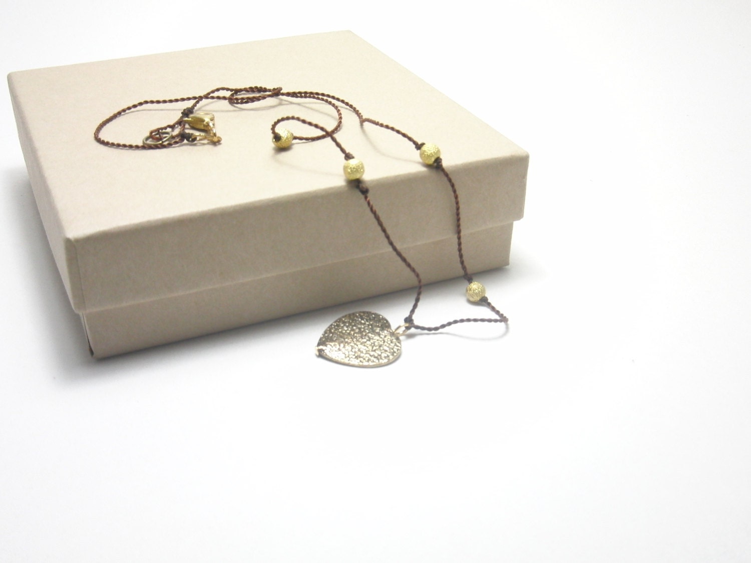 Golden Heart in a Brown Cord