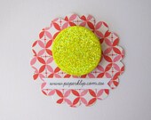 A neon yellow glitter brooch