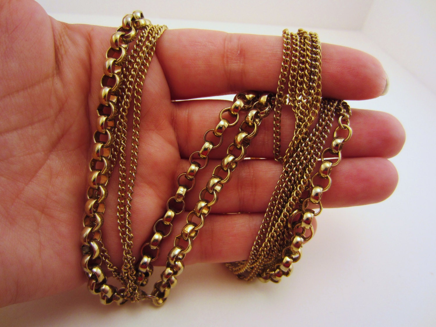 Extra long gold toned vintage necklace. 50 inches. Wear single, double or triple strand. Two types of chain. Clasp.