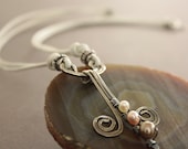 Artsy cross sterling silver necklace on white leather with pearl stick and swirly dangles pendant