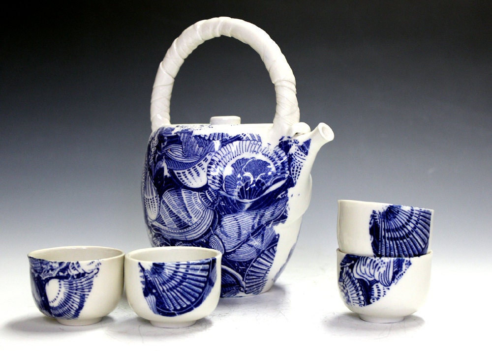 Pottery and ceramic tea set with four matching bowls.