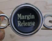Margin release typewriter key bracelet