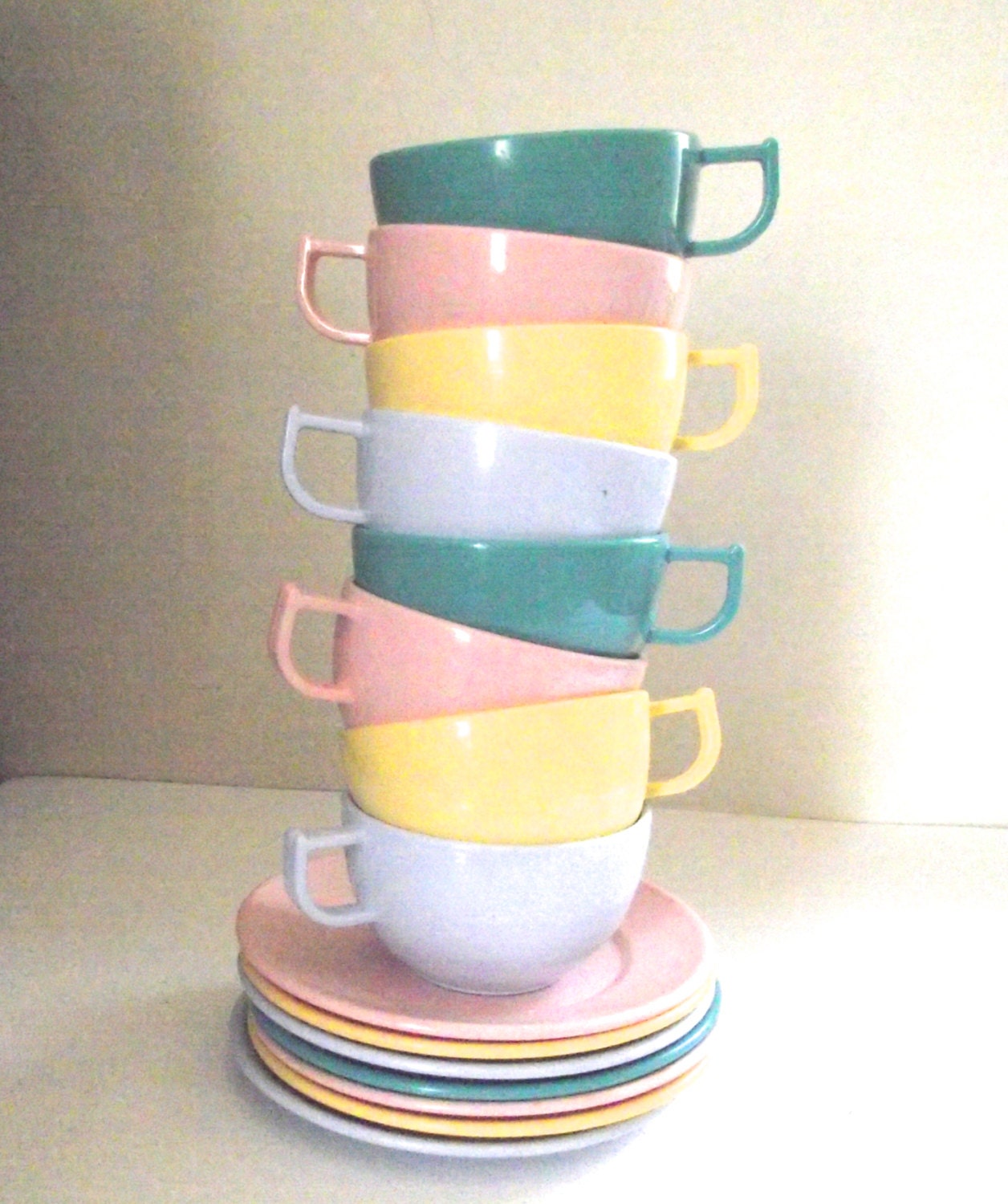 plastic tea cups with saucers