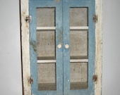 small shabby painted rustic wooden cupboard with screen doors