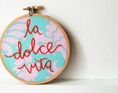 Embroidered Hoop Sign "la dolce vita" Cotton Fabric Wall Piece. Red Stitched Phrase on Pastel Paisley. Handmade by merriweathercouncil - merriweathercouncil