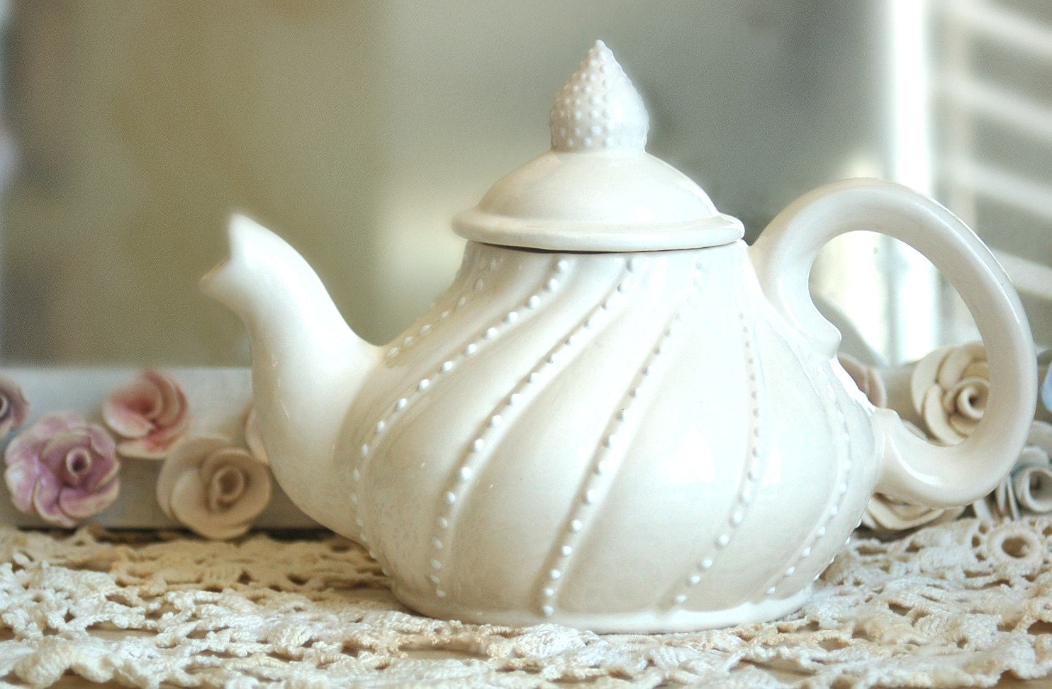 Cream white lace teapot with a swirled design