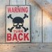 Warning turn back sign made from reclaimed plywood