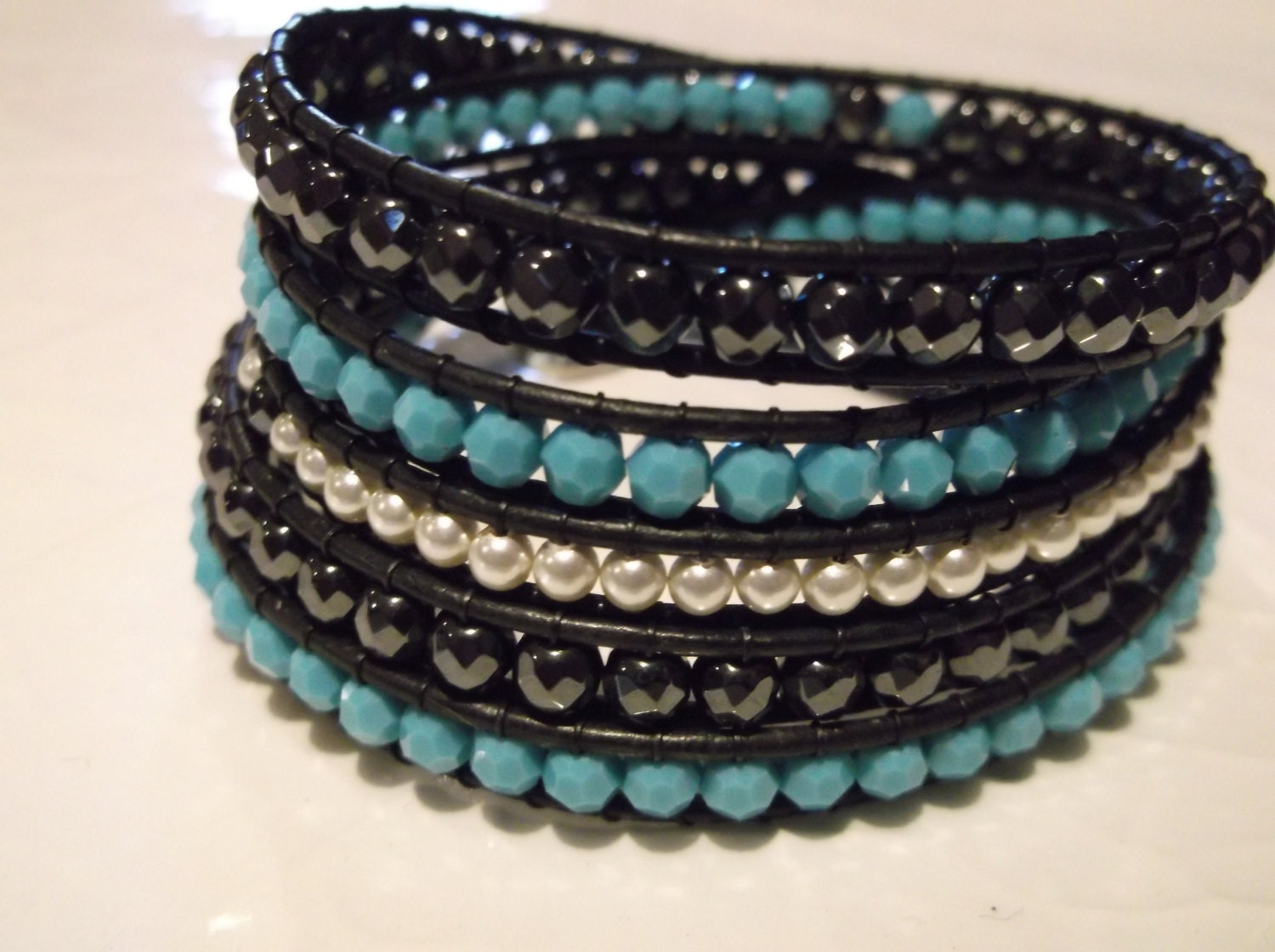 5 wrap chan luu inspired bracelet made with faceted turquoise swarovski crystals, faceted hemitite and swarovski pearls.