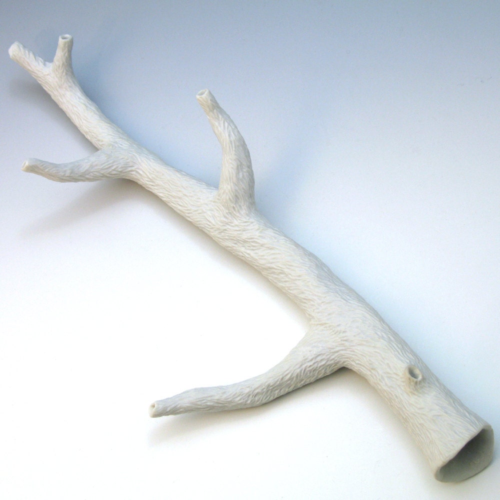 Hand-carved white porcelain faux bois branch with 4 side branches, one knot