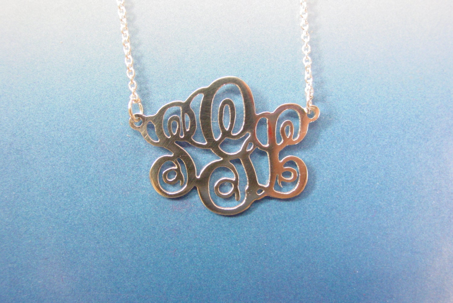 monogram necklace. 1 '' from side to side .75" top to bottom size,sterling silver monogram. with a chain.