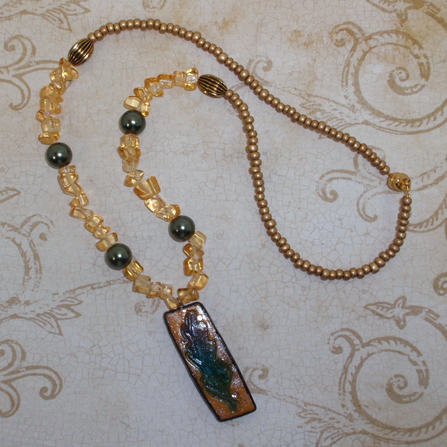 Gold and Green Pearls Beaded Necklace with Polymer Clay Leaf and Embedded Crystals Pendant
