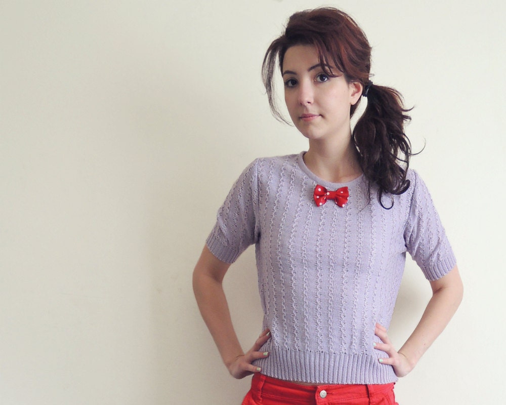 Lavender sweater with red polka dot leather bow . Paola