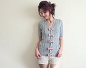 Soft gray cardigan sweater with pastel pink leather bows . Minnie