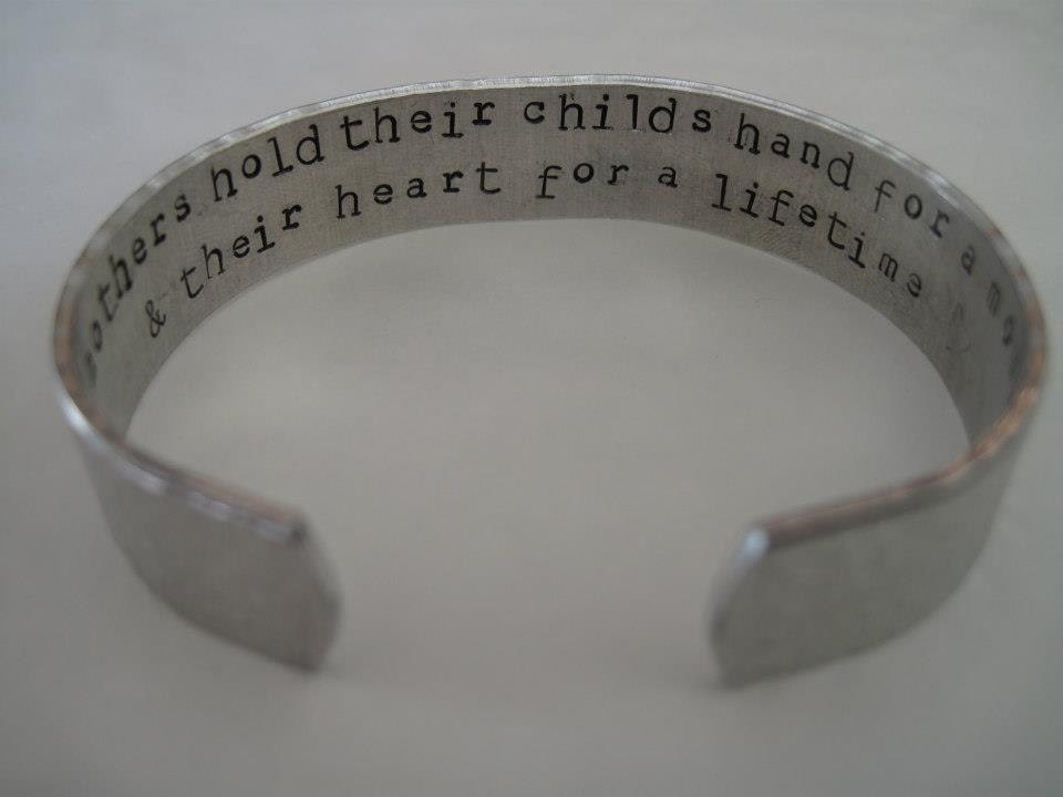 Mothers hold their child's hand...bangle