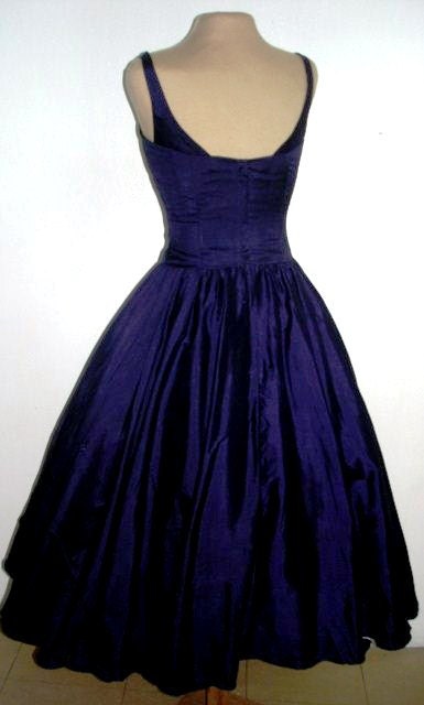A sexy yet elegant 50s style cocktail dress in gorgeous deep blue satin