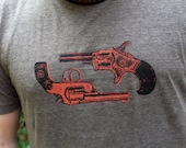 Dueling Victorian revolvers in orange on a brown mens t-shirt