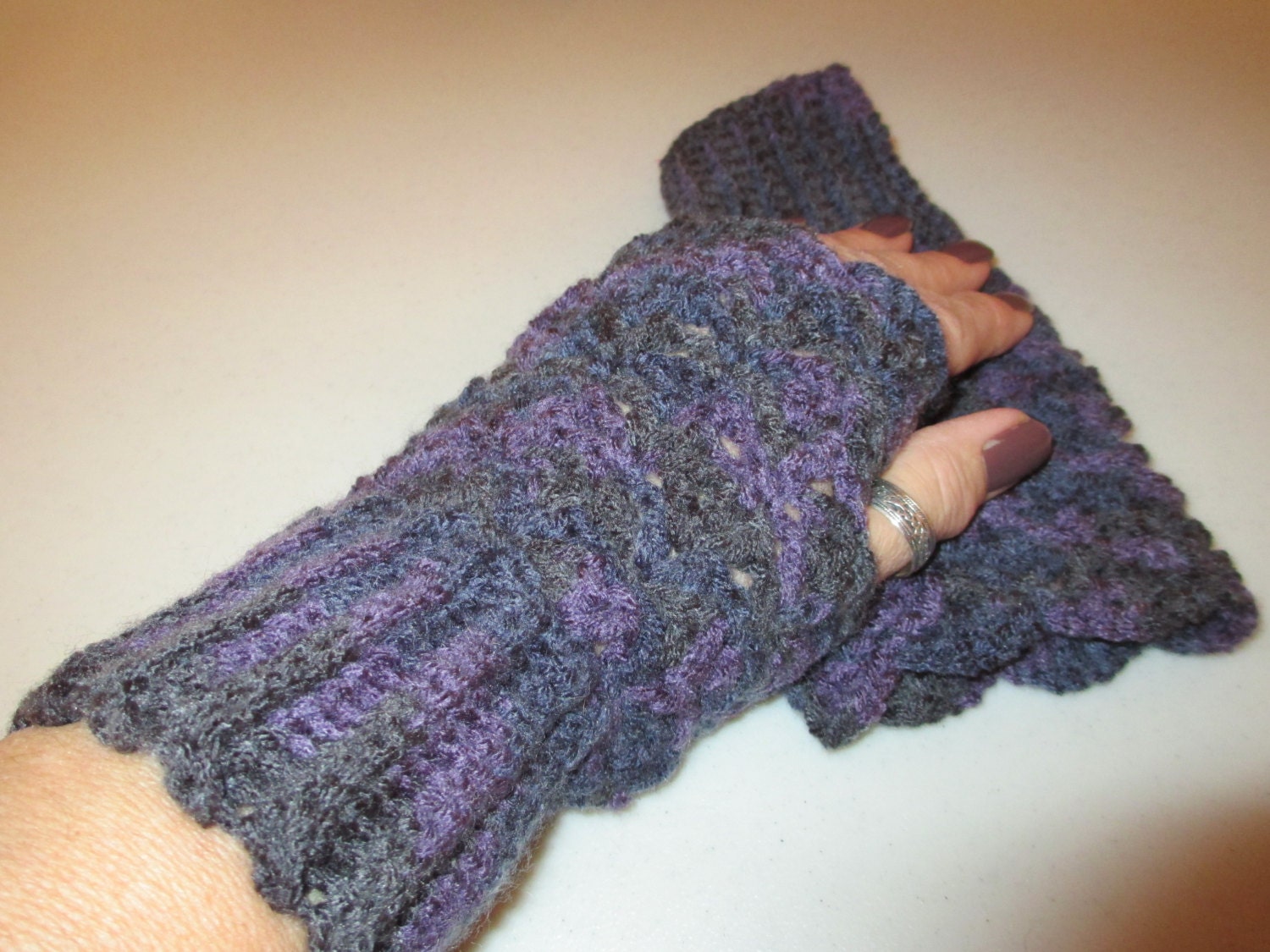 Handmade crocheted fingerless gloves/wrist warmers in purple and gray.