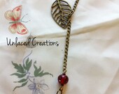 lena. a leaf and sun brass necklace