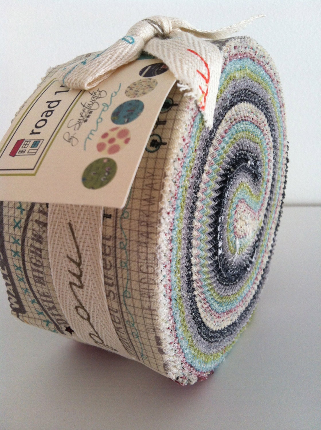 Moda "Road 15" Jelly Roll by Sweetwater. Modern and funky fabrics in colours of aqua, grey, red, black and green.