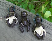 Set of three miniature black bisque baby dolls from the 1930s