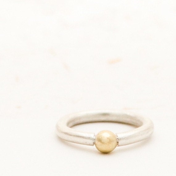 Silver ring with golden ball