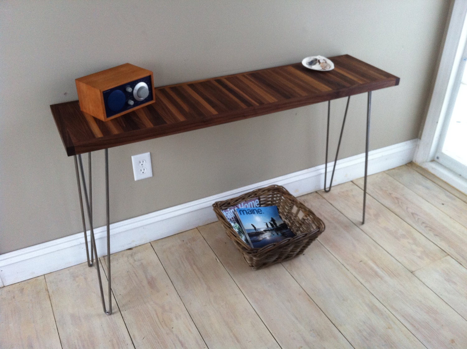 Mid century modern sofa table or console table featuring walnut top and hairpin legs.