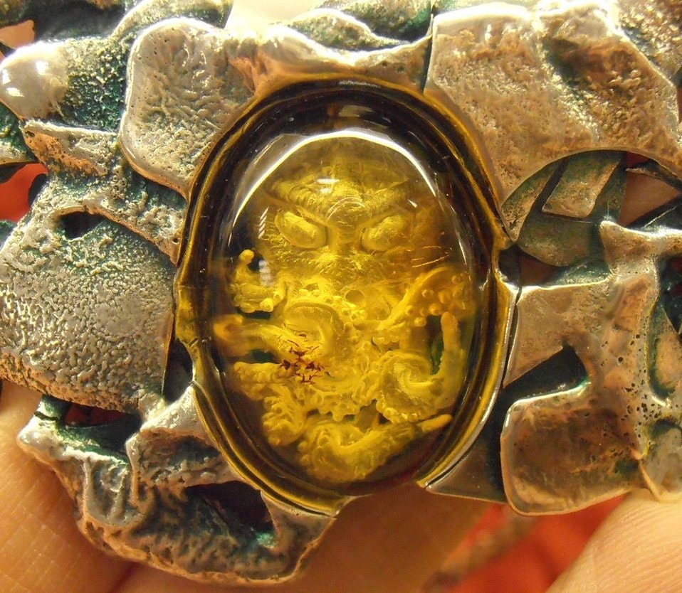 Cthulhu carved amber necklace in sterling silver - featured on Propnomicon