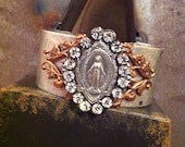 Silver metal cuff bracelet with religious medal