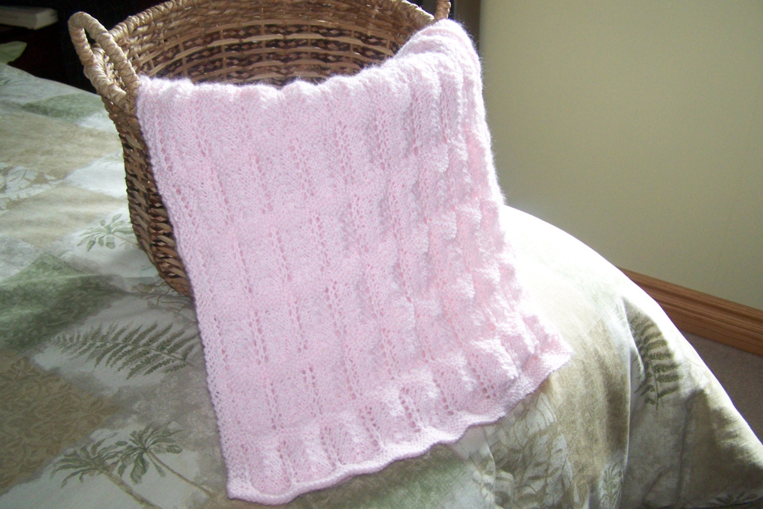 Hand knit baby blanket in soft pink baby yarn
