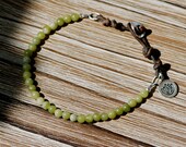 yoga bracelet. lotus charm bracelet in saguaro serpentine. leather. green. silver bracelet. artisan. handmade jewelry. spiritual jewelry