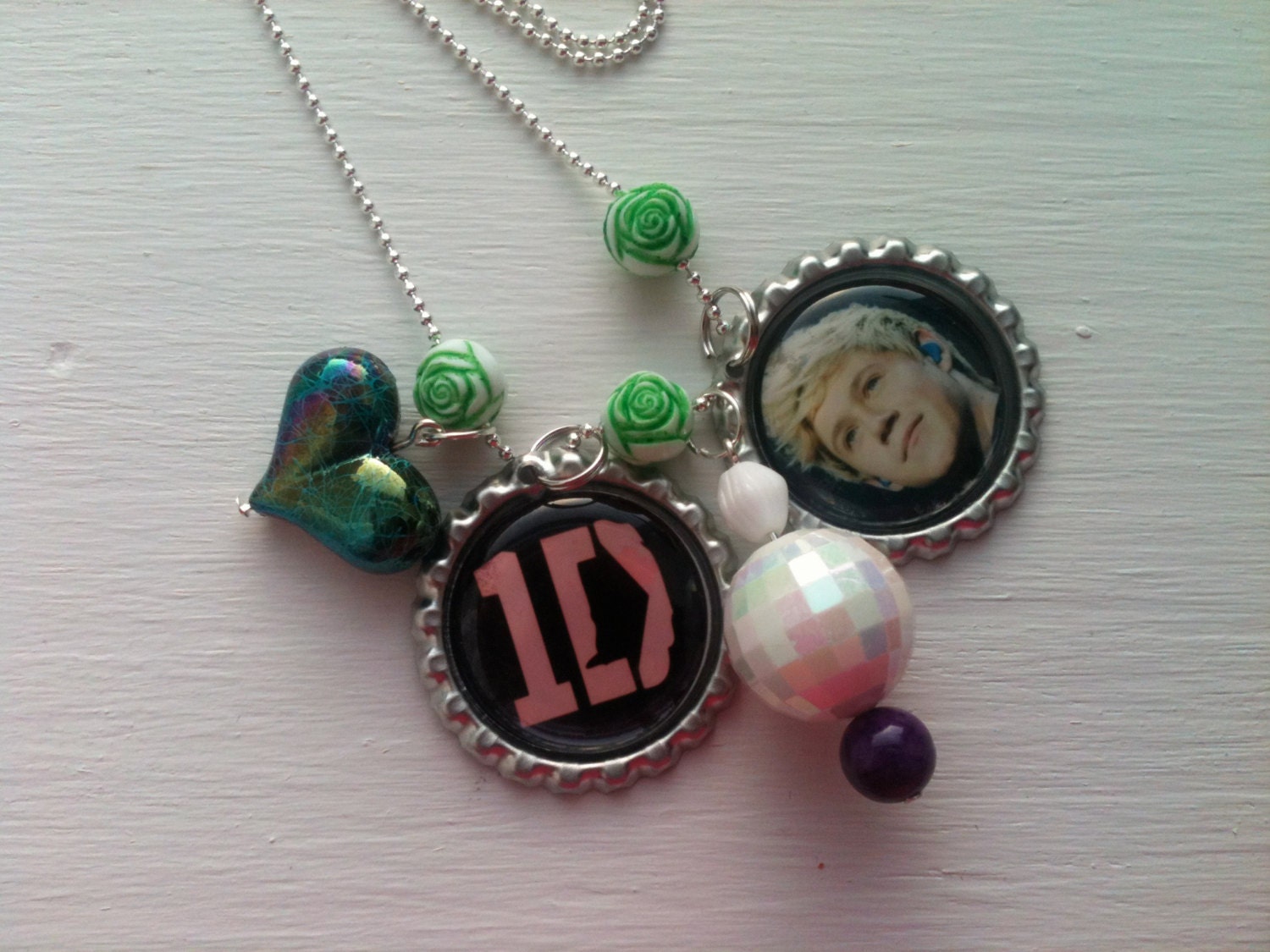 One Direction 1D Niall Horan bottle cap necklace with rose, pearled, and heart shaped beads on a 32" silver plated ball chain.