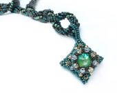 Ornate green beaded pendant