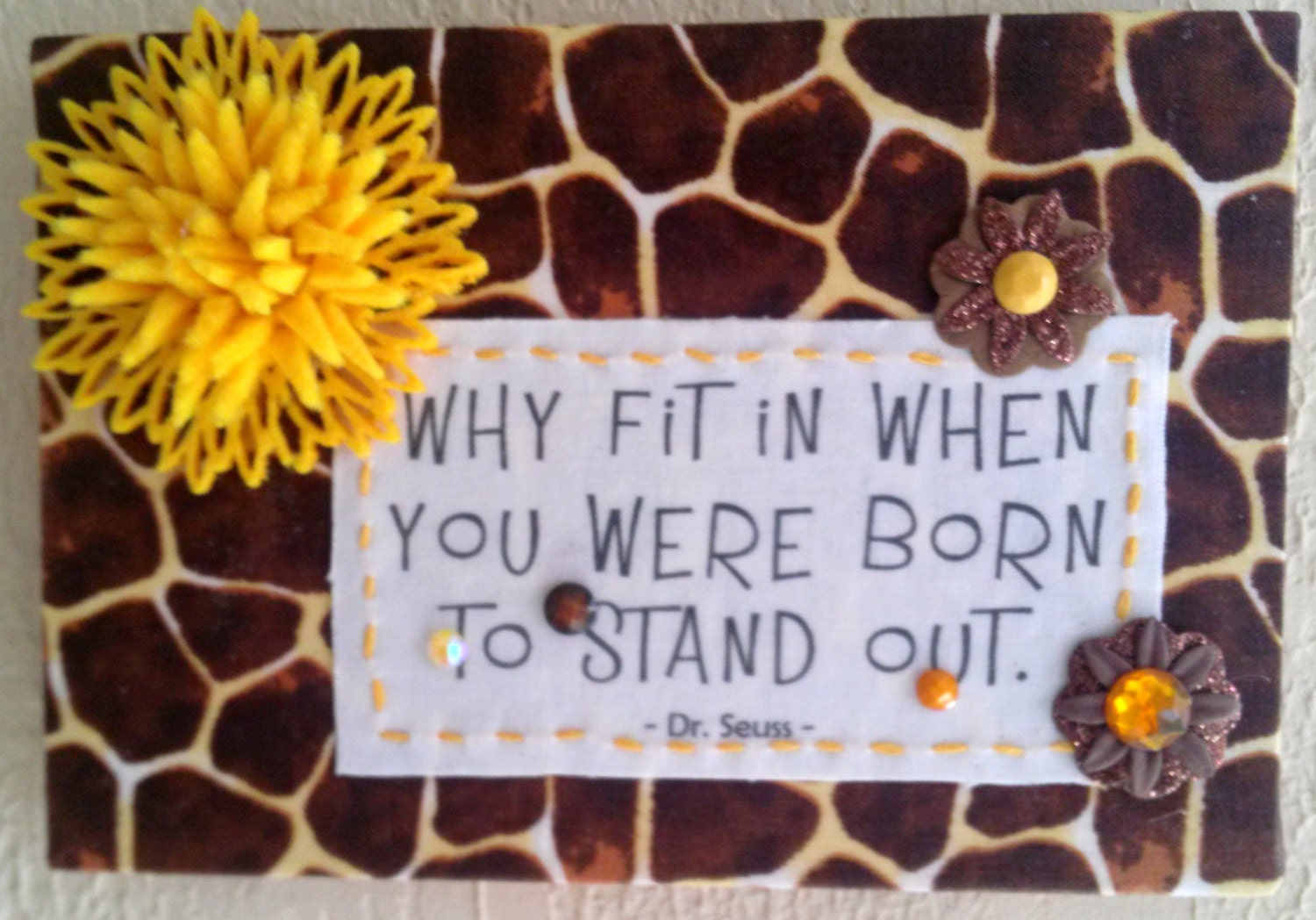 Why fit in when you were  born to stand out. Quote by Dr. Seuss on giraffe pattern fabric and beautifully embellished