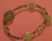 Fun yet Simple Handmade Bracelet using Glass and Acrylic Beads set on Stretch Cord. Jade/Green/Clear with Swarvsky crystal beads.