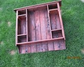 Rustic entry way coat and key rack made of reclaimed fence wood.