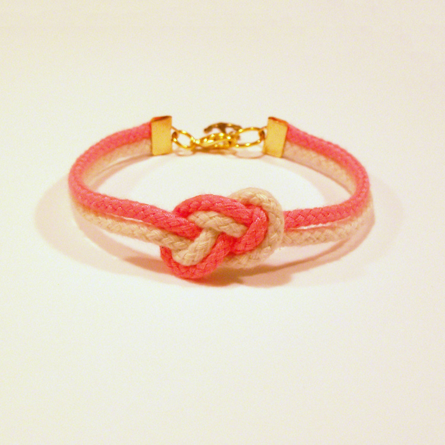 Matte neon pink and natural beige infinity knot nautical rope bracelet with gold anchor charm