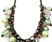 Handmade Wire Wrapped Necklace With Pink And Green Beads Dangling From A Brass Chain