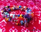 flora. a colourful beaded memory wire bracelet.