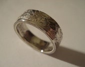 The Canadian Maple Leaf features on this 50 Cent Piece Coin Ring