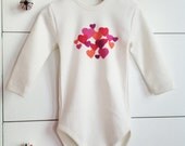 Handprinted cotton organic baby bodysuit with hearts long sleeves