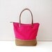 Waxed canvas tote bag with zipper and leather handles in fuscia and tan