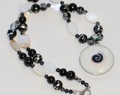 Black and white beaded necklace with swirl pendant