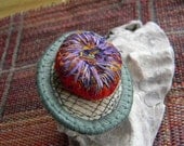 tiny homage sewn fiber brooch to artist Judith Scott