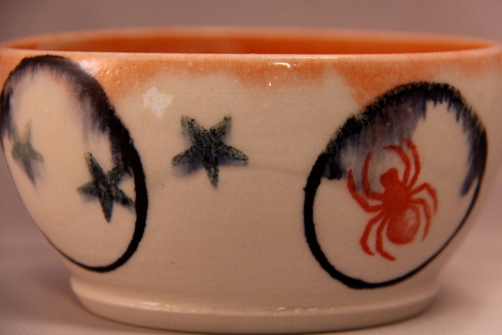 orange and while bowl with spider circles and stars