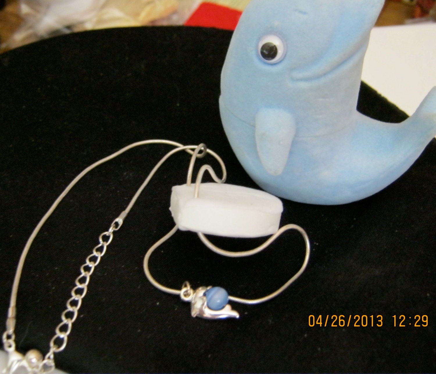 Dolphin necklace with blue movable cat's eye bead