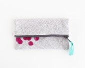 Grey and white geometric print with magenta fold over clutch