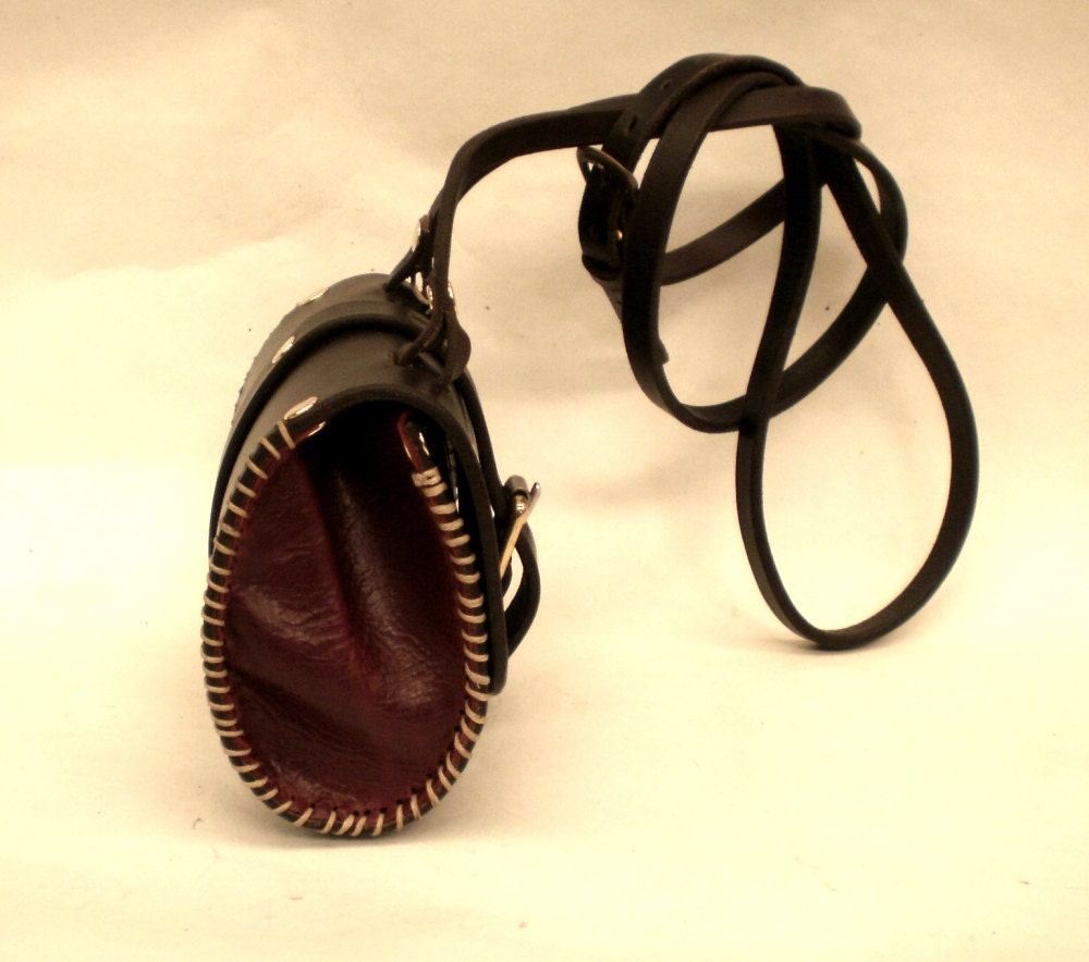 small rustic leather bag with handstitching and burgandy gussset